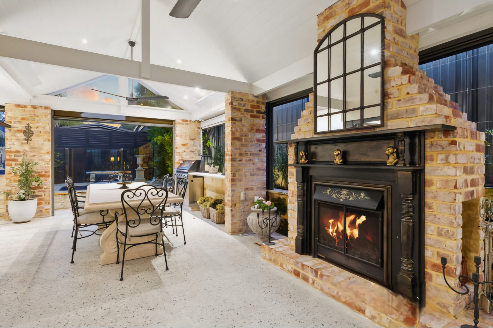 Melville alfresco with recycled brick fireplace and vaulted ceiling