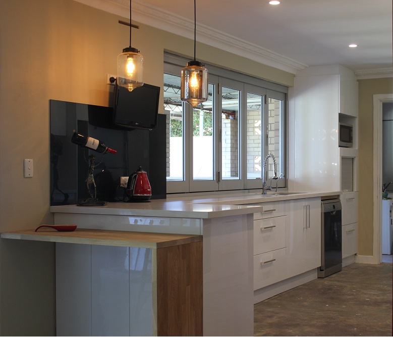 Dianella kitchen with breakfast bar, pendant lights and black glass splashback